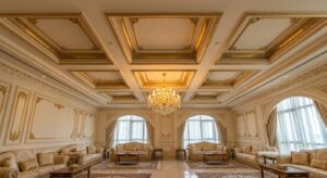 Coffered gypsum board ceiling in a Dubai majlis with chandelier and ivory and gold finish