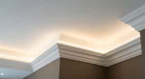 Concealed LED cove lighting inside GRG cornices creating an even indirect glow on a villa ceiling